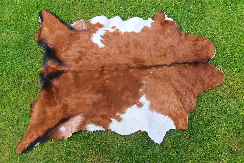 Brown and White Tricolor Goatskin Rug